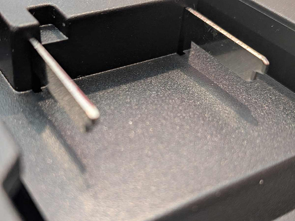 Einhell 18V PXC to Milwaukee M18 battery adapter - close-up of the battery-side connection with twin blade terminals