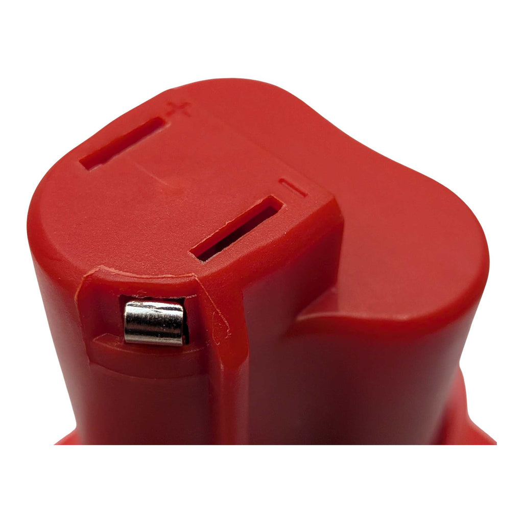 Milwaukee M18 to Milwaukee M12 battery adapter - close-up of the tool-side connection, terminal slots and polarity marks